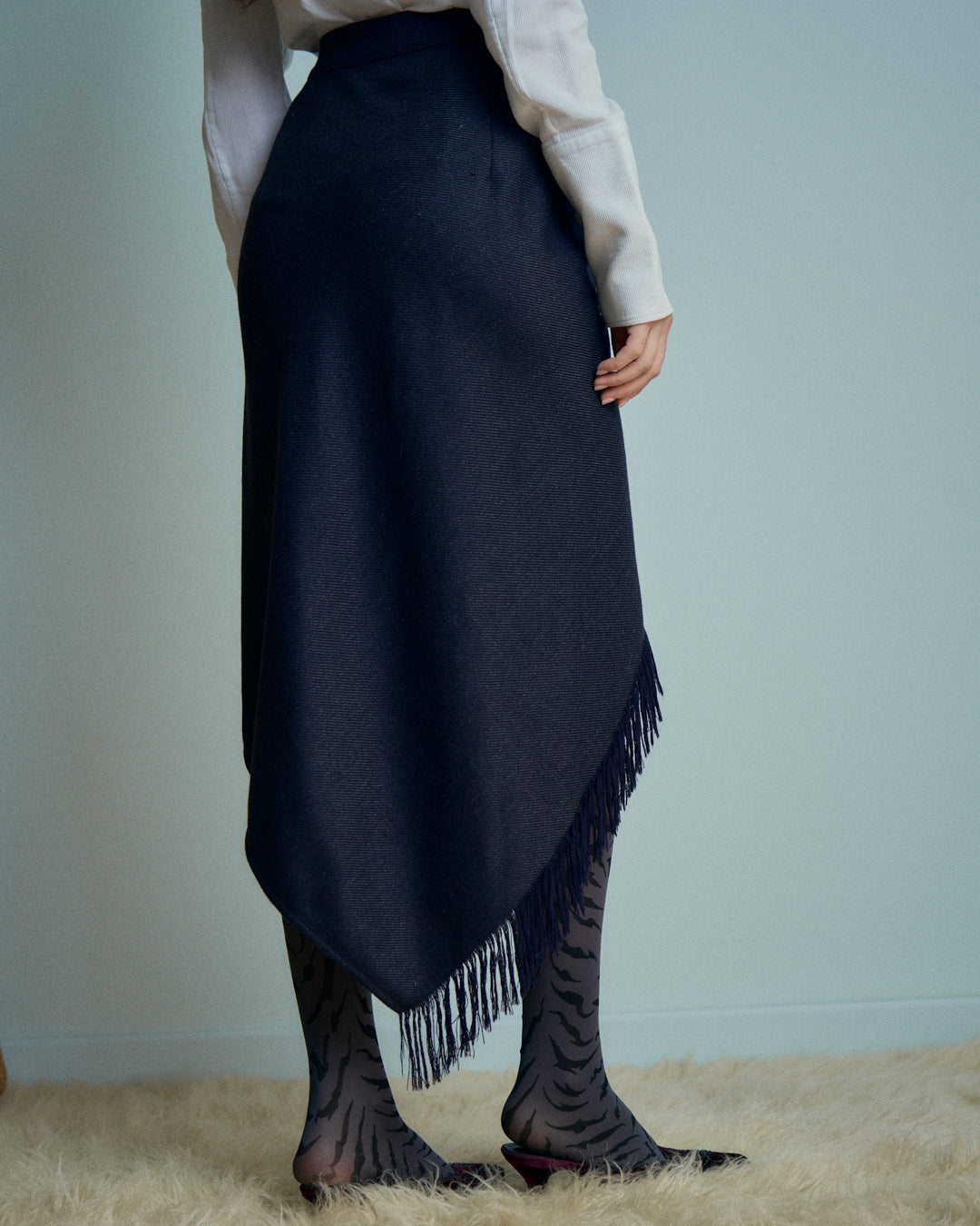 Gonna Erreuno in lana spinata con frange asimmetrica